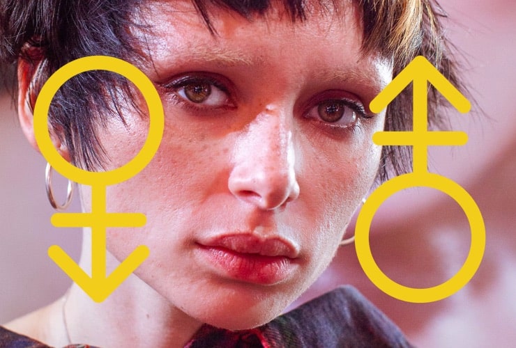 Androgynous person with short hair and no eyebrows